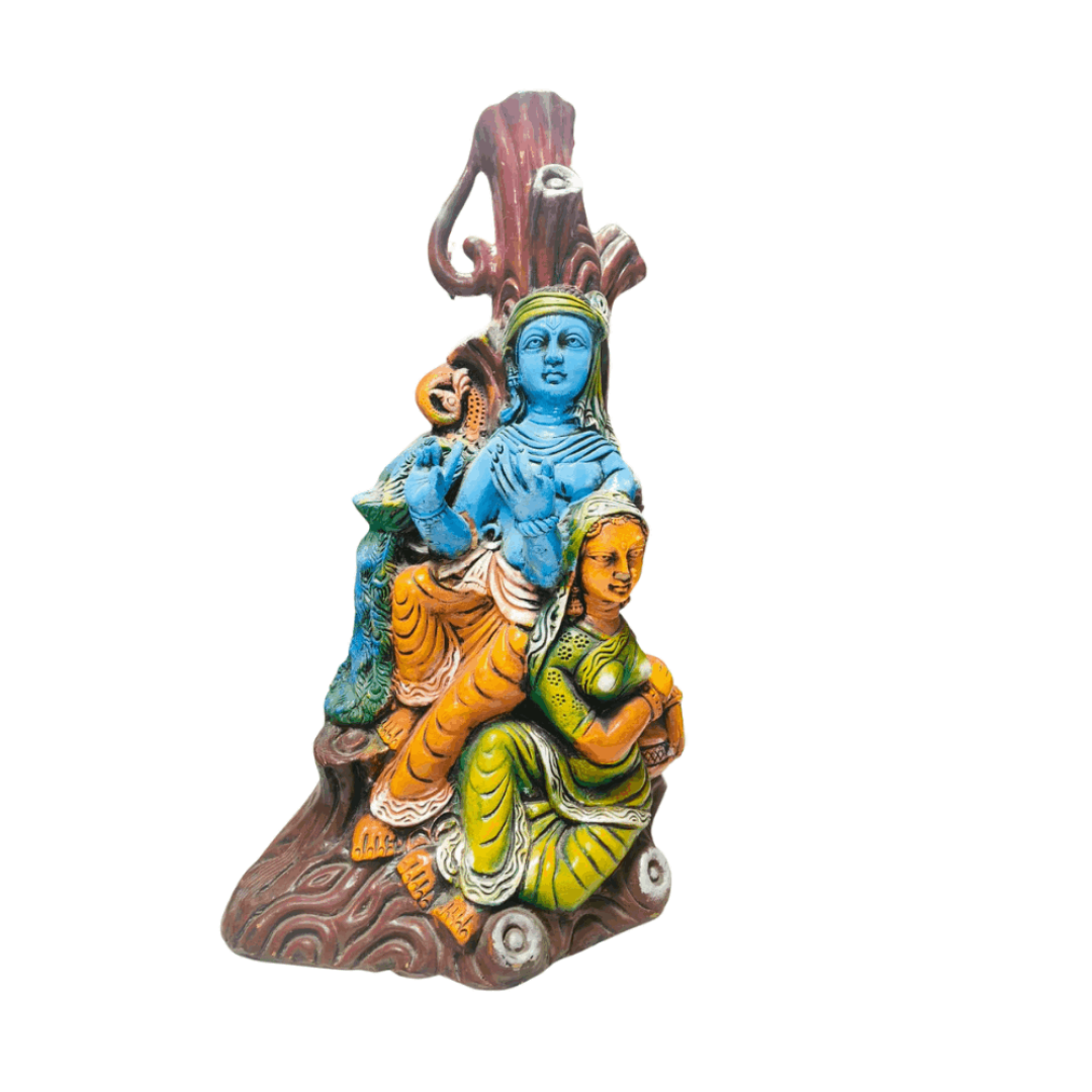 Colorful Radha and Krishna Statue sitting together under a tree